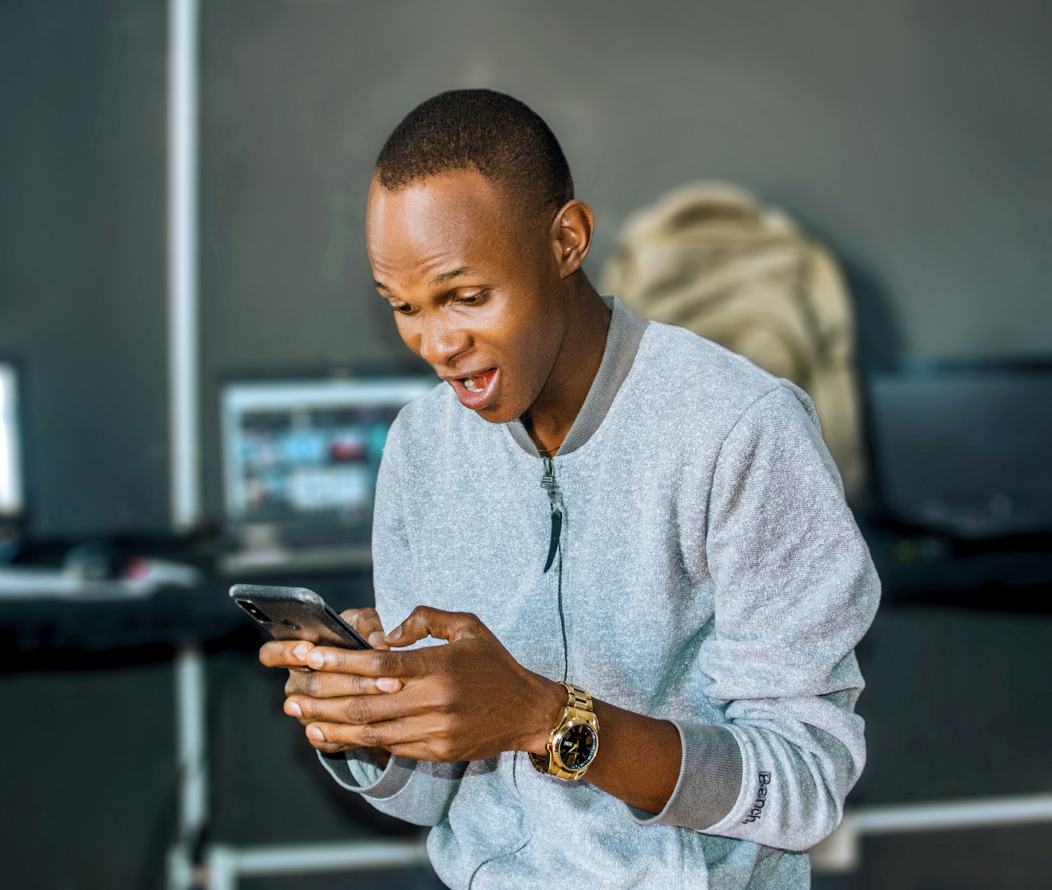 A Nigerian man using a smartphone