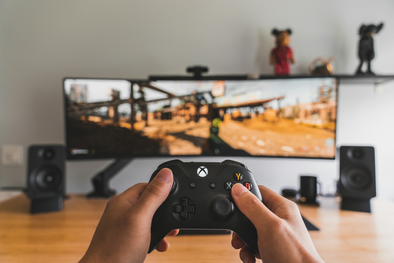 A player holding a controller at a gaming setup