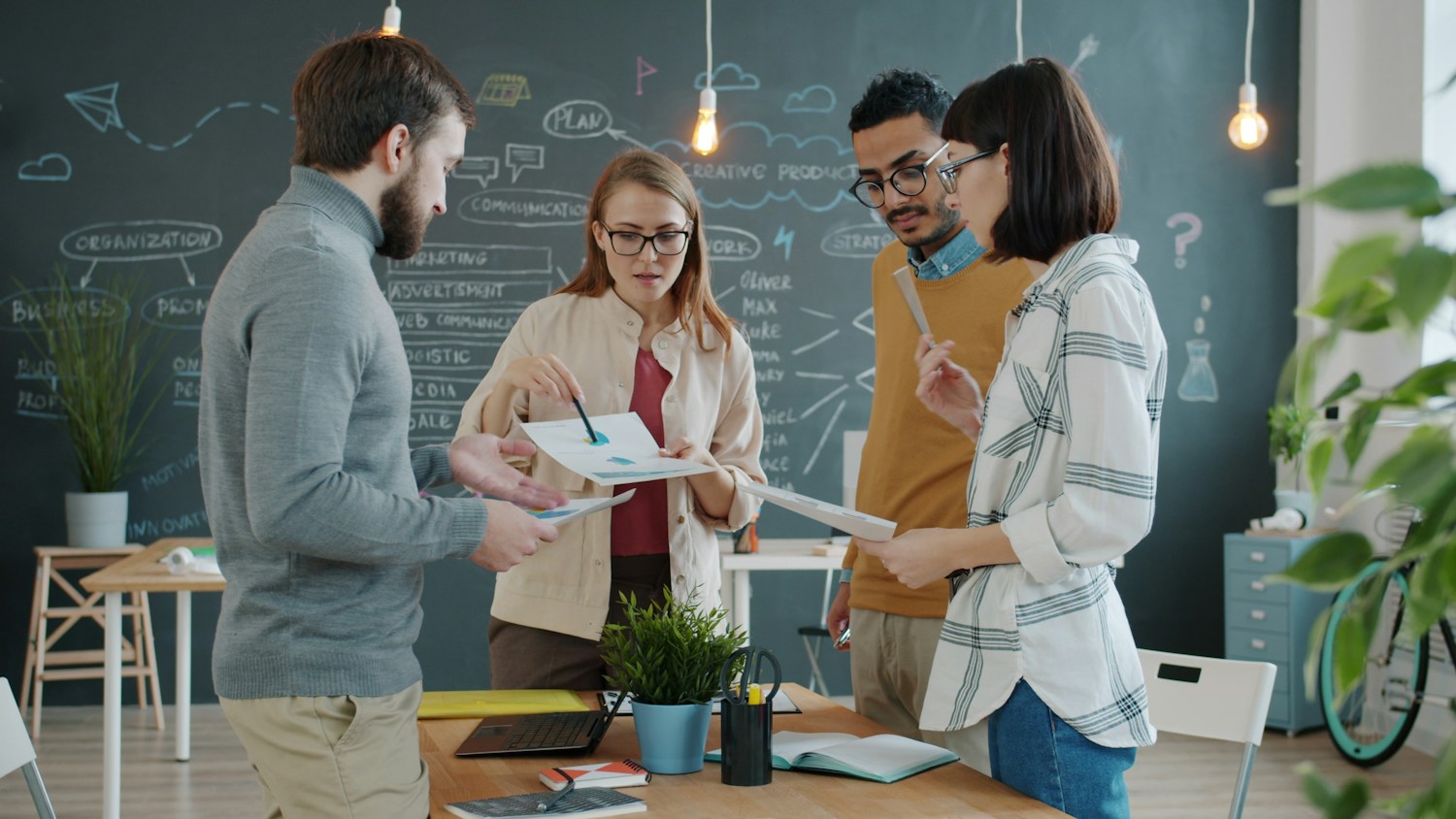 A diverse team reviewing a project together in an office